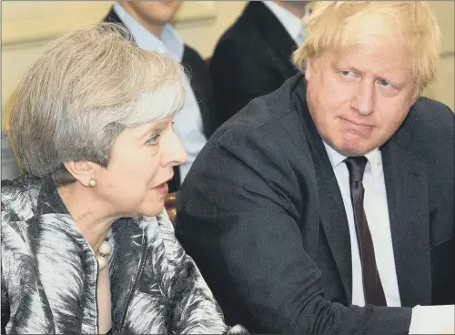  ?? PICTURES: LEON NEAL/PA WIRE. ?? STILL IN CHARGE: Prime Minister Theresa May with Foreign Secretary Boris Johnson as she holds the first Cabinet meeting since the General Election.