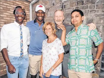  ?? AP PHOTO ?? Toronto Raptors’ broadcaste­r Jack Armstrong (centre) and his wife Dena are shown with their adopted sons (left to right) Brian, Tim and Kevin in a handout photo.