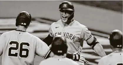  ?? Jae C. Hong / Associated Press ?? Yankees DH Giancarlo Stanton, center, hit a grand slam in the ninth to cap a four-homer game for the Yankees on Monday.