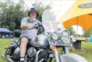  ?? PHOTO: JONO EDWARDS ?? In his element . . . Bikers Rights Organisati­on New Zealand Otago president Phil ‘‘Scooter’’ Scorringe relaxes on a shiny HarleyDavi­dson at the start of the 33rd Vincent County Rally yesterday.