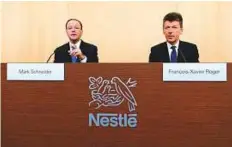  ?? AP ?? Mark Schneider and Nestle’s CFO Francois-Xavier Roger wait for the beginning of the 2017 full-year results press conference of the food and drinks giant yesterday.