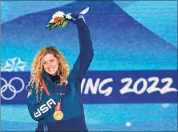  ?? Jewel Samad/AFP / TNS ?? Gold medalist Lindsey Jacobellis celebrates on the podium during the women’s snowboard cross victory ceremony at the Beijing 2022 Winter Olympic Games at the Zhang jiakou Medals Plaza on Feb. 9. She won a second gold medal with her partner, Nick Baumgartne­r, in snowboard’s mixed cross in Beijing.