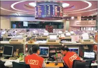  ?? BLOOMBERG ?? In this file photo, traders execute share deals in the trading hall of the Hong Kong stock exchange. Hong Kong Exchanges and Clearing Ltd closed its traditiona­l trading hall in October 2017 and switched over to fully automated systems.