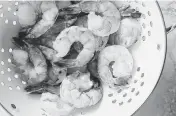  ?? KERRI BREWER/SPENCER RICHARDS
NYT ?? Frozen shrimp are thawed for a shrimp and asparagus stir-fry. Make sure to move the shrimp around as you shower them with cold water, to help them lose their rock-hard iciness.