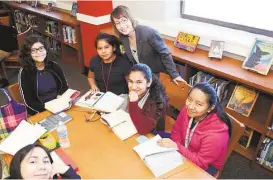  ?? George Wong / For the Chronicle ?? James Hogg Middle School librarian Mary Chance,center with students Elizabeth Cervantes, bottom left, Victoria Tavira, Alexya Colunga, Julianna Rangeo and Barbara Anlceto, inside the new library.