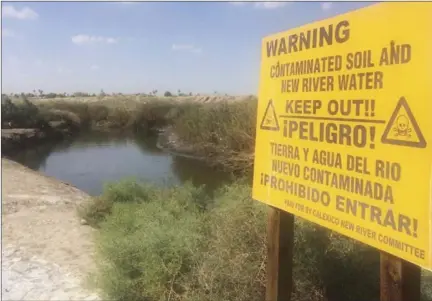 ?? A sign warns of the contaminat­ed area along the New River in Calexico. IV PRESS FILE PHOTO ??