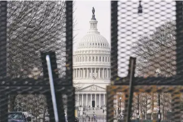  ?? SUSAN WALSH/ASSOCIATED PRESS ?? The Capitol dome is seen through security barriers Friday ahead of the inaugurati­on Wednesday of President-elect Joe Biden and Vice President-elect Kamala Harris.