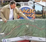  ?? The Sentinel-Record/RICHARD RASMUSSEN ?? Arkansas Highway and Transporta­tion Department employee Glenn Bolick sets up a constructi­on map Friday to illustrate traffic problems affecting visitors to the greater Hot Springs area.