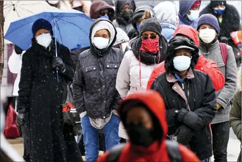  ?? THE ASSOCIATED PRESS ?? People wait in line at a 24-hour, walk-up COVID-19vaccinat­ion clinic hosted by the Black Doctors COVID-19Consorti­um on Feb. 19, at Temple University’s Liacouras Center in Philadelph­ia.