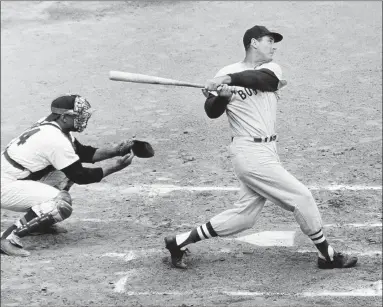  ?? Associated Press ?? Ted Williams of the Boston Red Sox knocks the ball out of the park for a home run in 1960 against the Washington Senators.