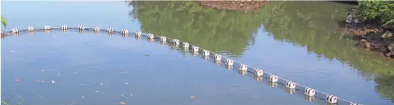  ?? Photo: Ministry of Environmen­t ?? Fiji’s first floating trash net installed close to Bailey Bridge, Samabula River in Suva.