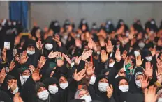  ?? AFP ?? Iranians wave as they attend supreme leader Ayatollah Ali Khamenei’s address in Tehran yesterday.