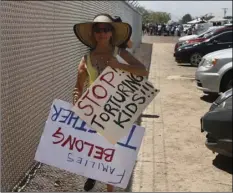  ?? PHOTO/CEDAR ATTANASIO ?? A grandmothe­r protesting the treatment of children in Border Patrol custody walks back to her car by a fence at a holding center in Clint, Texas, July 1. AP