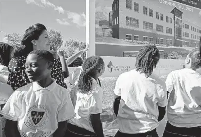  ?? JERRY JACKSON/BALTIMORE SUN ?? Future students of Mother Mary Lange Catholic School check out the rendering after it was unveiled at Wednesday’s groundbrea­king.