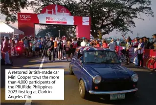  ?? ?? A restored British-made car Mini Cooper tows the more than 4,000 participan­ts of the PRURide Philippine­s 2023 first leg at Clark in Angeles City.