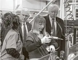  ?? Timothy A. Clary / AFP / Getty Images file ?? A Carrier plant in Indianapol­is that President Donald Trump and Vice President Mike Pence visited before their inaugurati­on has begun laying off workers.