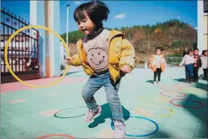  ?? WANG GUANSEN / XINHUA ?? At study and play, young Chinese, such as this girl at a kindergart­en in Yunnan’s Zhenxiong county on Nov 11, enjoy facilities that have improved greatly over the decades.