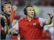 ?? SUE OGROCKI — THE ASSOCIATED PRESS FILE ?? Ohio State head coach Urban Meyer, right, and thenassist­ant coach Zach Smith, left, gesture from the sidelines during a 2016 game against Oklahoma in Norman, Okla.