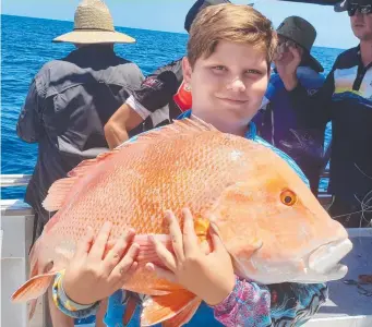  ?? Young Jack Rushton shows off his hefty red emperor. ??