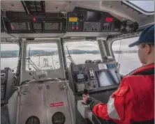  ?? ?? A Coast Guard coxswain at the controls of a 45-foot boat