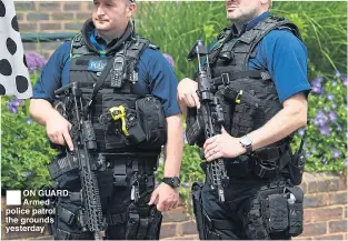  ??  ?? ON GUARD: Armed police patrol the grounds yesterday