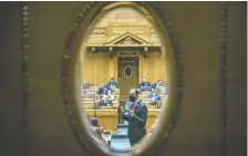  ?? KAYLE NEIS ?? Seen through a side door, NDP Leader Ryan Meili makes a point to MLAS as he rises for the last time in the legislatur­e.