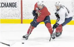  ?? TAIMY ALVAREZ/STAFF PHOTOGRAPH­ER ?? Panthers’ 2018 draft pick left wing Justin Schutz, left, passes the puck to a teammate as center Tyler Soy comes up from behind during a scrimmage.