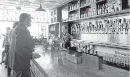  ?? James Nielsen / Houston Chronicle, Julie Soefer, Houston Chronicle ?? From left, 101 Reserve owner Mike Raymond mixes a cocktail; a Classic Martini at Anvil Bar & Refuge; creative cocktails can be found at Midtown’s Wooster’s Garden.