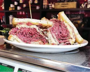  ?? Mike Sutter / Staff ?? The towering and satisfying Reuben sandwich, which can be ordered with pastrami, corned beef or both, is topped with sauerkraut, Swiss cheese and Thousand Island.