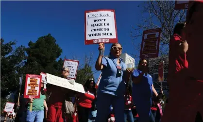  ??  ?? Caregivers and nurses protest changes to their sick leave benefits in Los Angeles. Photograph: Frederic J Brown/AFP via Getty Images