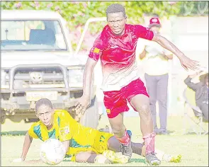  ?? (Pic: Mengameli Mabuza) ?? Seven Dreams striker Banele Shabangu (R) dribbled past Tambankulu Callies defender Muhle Siyaya during their MTN National First Division ( NFD) match played at the Prince of Wales Sports Ground yesterday. Seven Dreams won the match 1-0.