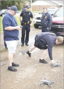  ?? Brodie Johnson • Times-Herald ?? The Forrest City Fire Department helped the city’s police department Friday by using its drones to try and locate pieces of evidence stemming from a murder last week outside a local convenienc­e store. FCFD Captain Justin Sharp, left, and Battalion Chief Zakk Jumper prepare the drones for flight.