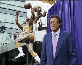  ?? ASSOCIATED PRESS FILE PHOTO ?? Elgin Baylor stands next to a statue honoring the Minneapoli­s and Los Angeles Lakers great, outside Staples Center in Los Angeles in 2018. The 11-time NBA All-Star and Basketball Hall of Famer, died Monday. He was 86.