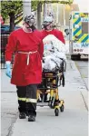  ?? JOHN RENNISON HAMILTON SPECTATOR FILE PHOTO ?? Paramedics leave The Rosslyn with patient during the evacuation of the facility.