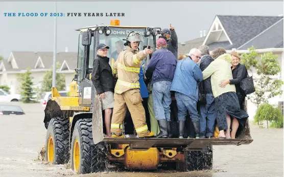  ?? LORRAINE HJALTE ?? A front-end loader was being used to rescue people from the rising flood waters of the Highwood River in High River on June 20, 2013.