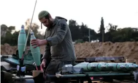  ?? Photograph: Amir Cohen/Reuters ?? An Israeli soldier prepares mortar shells before firing them as part of the offensive against Gaza.