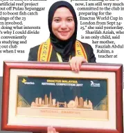  ??  ?? Sharifah Aziah with the plaque she received on winning this year's Enactus Malaysia national competitio­n.