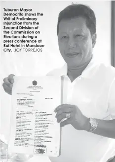  ?? JOY TORREJOS ?? Tuburan Mayor Democrito shows the Writ of Preliminar­y Injunction from the Second Division of the Commission on Elections during a press conference at Bai Hotel in Mandaue City.