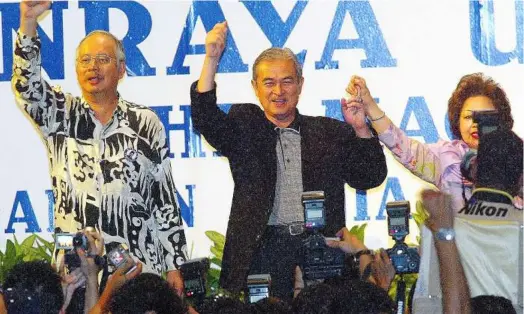  ??  ?? A big win: Tun Abdullah Ahmad Badawi celebratin­g his sweeping win with his deputy Datuk Seri Najib Tun Razak