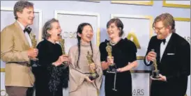  ?? AFP ?? (Left to right) Producers Peter Spears, Frances Mcdormand, Chloe Zhao, Mollye Asher and Dan Janvey, winners of the award for best picture for Nomadland, pose in the press room at the Oscars.