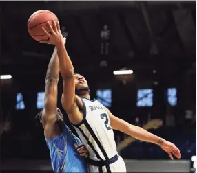  ?? Darron Cummings / Associated Press ?? Butler’s Aaron Thompson puts up a shot against Creighton’s Denzel Mahoney during the second half on Saturday in Indianapol­is. Butler won 70-66 in overtime.