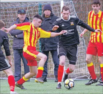  ?? Photograph­s: Iain Ferguson, alba.photos ?? Lewis Campbell sweeps the ball from an Erskine opponent.