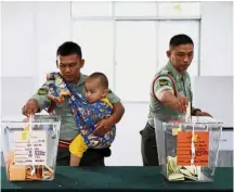  ?? — Bernama ?? Doing their duty: Two soldiers casting their GE14 votes at Kem Paradaise Kota Belud.