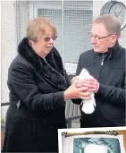  ??  ?? Symbolic Moira’s sister Janet and Dermot Lamb, a friend of the foundation, prepare to release one of the doves