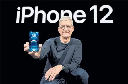  ?? Provided by Brook Kraft, Apple Inc. via Getty Images ?? Apple CEO Tim Cook holds the iPhone 12 Pro at Apple Park on Tuesday during its unveiling in Cupertino, Calif.