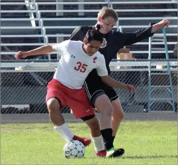  ??  ?? LFO’s Edgar Perez jockeys for position with LaFayette’s Matthew Newsom during Friday’s clash at Tommy Cash Stadium. The Warriors won the match, 2-1. (Catoosa County News photo/Scott Herpst)
LFO boys 2, LaFayette 1 Ringgold 13, Bremen 0