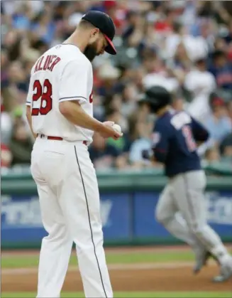  ?? TONY DEJAK — THE ASSOCIATED PRESS ?? Indians starting pitcher Corey Kluber waits for the Twins’ Brian Dozier to run the bases after Dozier hit a two-run home run during the fourth inning.