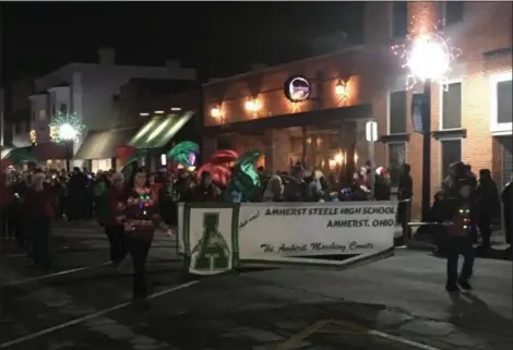  ?? KEVIN MARTIN — THE MORNING JOURNAL ?? The Amherst Steele High School Marching Band participat­es in the 13th annual Miracle on Main Street parade in downtown Amherst.