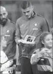  ?? MATTEO BAZZI, THE ASSOCIATED PRESS ?? Inter captain Mauro Icardi signs Anne Frank’s diary for a child, prior to an Italian Serie A soccer match against Sampdoria in Milan, Italy, on Tuesday.