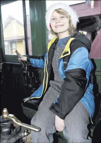  ?? BRAD COMAN/NEVADA APPEAL VIA AP ?? Danton Williams, who finished chemothera­py in January, operates the controls of Old No. 25 on Dec. 17 at the Nevada State Railroad Museum in Carson City. Nevada State Railroad Museum’s Special Santa Train is dedicated to children battling cancer.